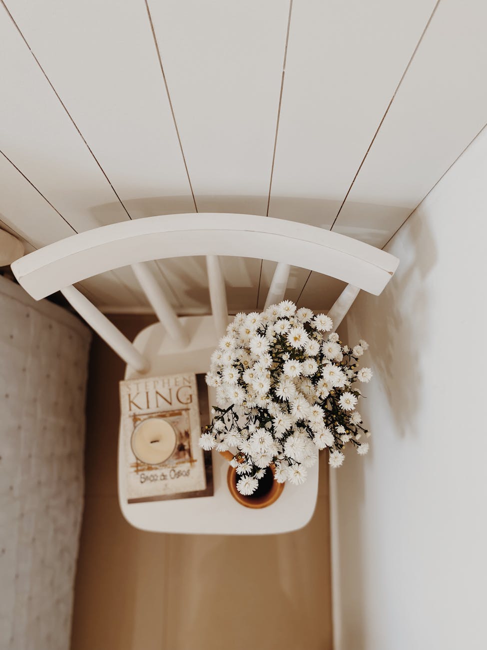 cozy minimalist bedside with flowers and candle